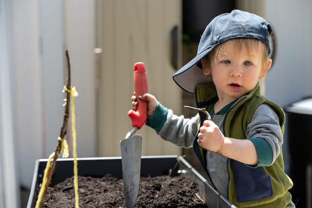 child digging in the garden