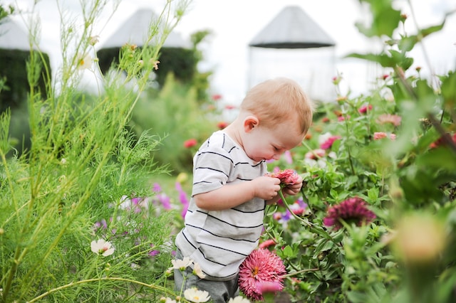 child enjoying the sensory elements of the garden